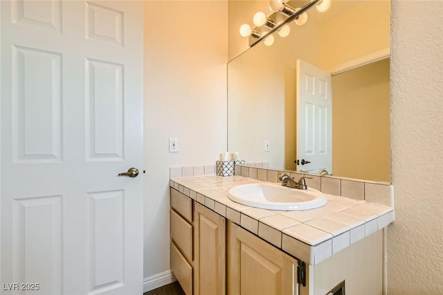 bathroom with vanity and baseboards