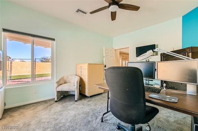 carpeted office with a ceiling fan, visible vents, and baseboards