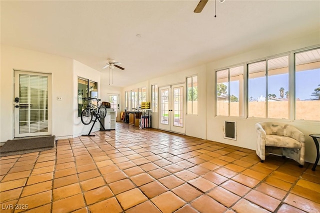 unfurnished sunroom with french doors and ceiling fan