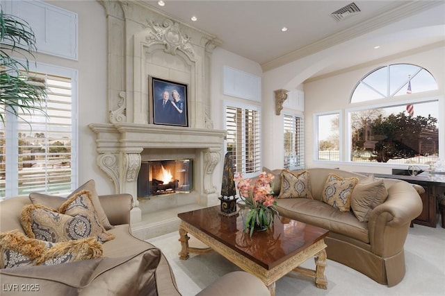 living room featuring visible vents, arched walkways, carpet flooring, crown molding, and a premium fireplace