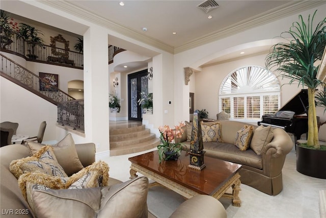 living area featuring visible vents, stairway, carpet flooring, recessed lighting, and arched walkways