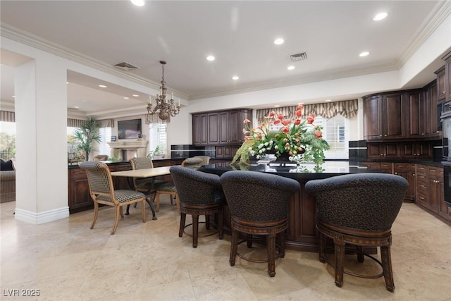 dining room with a notable chandelier, recessed lighting, visible vents, and ornamental molding