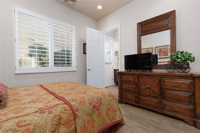 bedroom featuring recessed lighting, visible vents, and light wood-style flooring