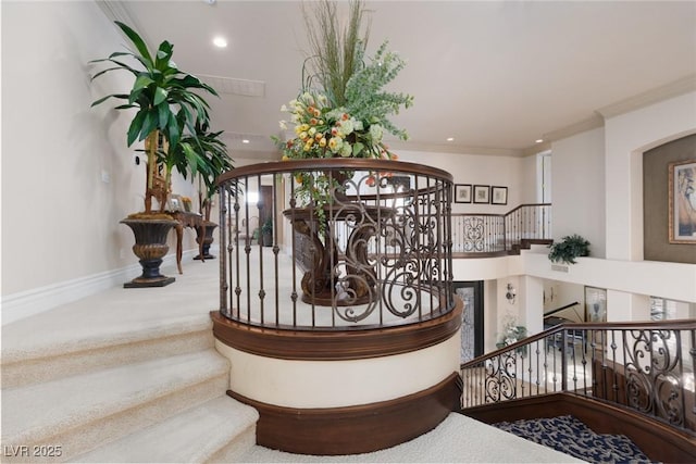 staircase featuring crown molding, carpet flooring, recessed lighting, and baseboards