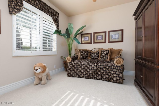 sitting room featuring carpet flooring and baseboards