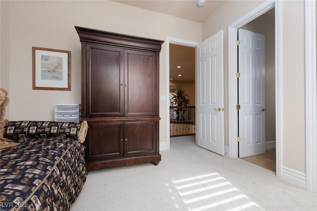 bedroom featuring baseboards and light carpet