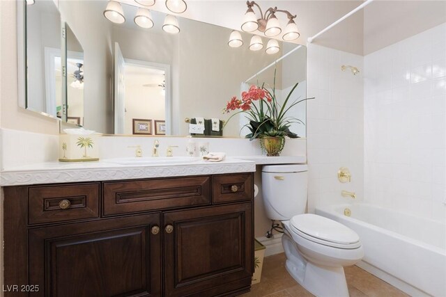 bathroom featuring tile patterned flooring, toilet, vanity, and bathtub / shower combination