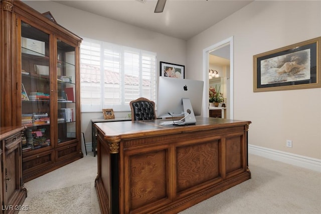 office space featuring light carpet, baseboards, and ceiling fan