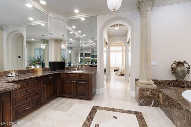 ensuite bathroom with vanity, baseboards, recessed lighting, ensuite bathroom, and crown molding