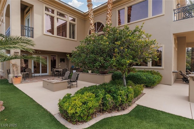 exterior space featuring a patio and an outdoor fire pit