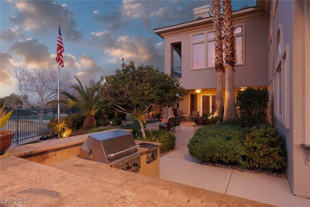 exterior space featuring a patio, a balcony, area for grilling, and fence