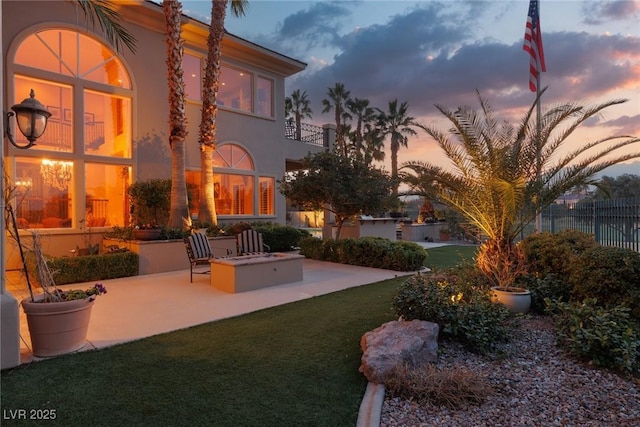 exterior space with a patio area, a balcony, and fence