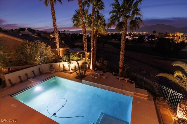 pool at dusk with a patio