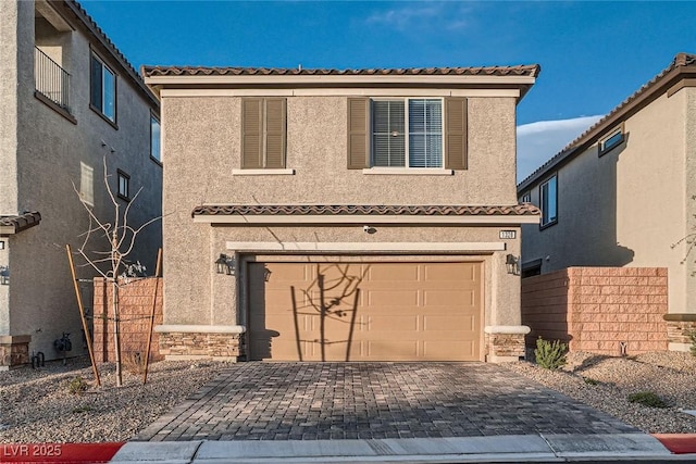 view of front of house featuring stucco siding, stone siding, and an attached garage