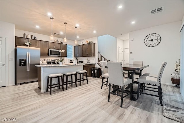 dining space with recessed lighting, light wood-style floors, visible vents, and baseboards