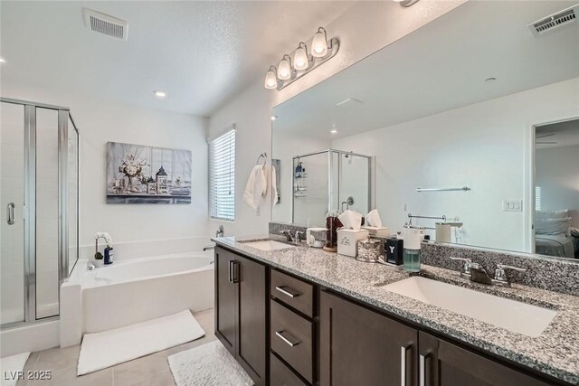 1328 Graphite Ave, Henderson, NV 89002 - bathroom featuring a garden tub, a shower stall, double vanity, and tile patterned flooring