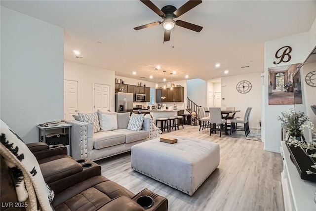 living room with light wood finished floors, recessed lighting, and ceiling fan