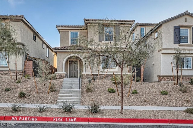 view of front of home with a tile roof and stucco siding