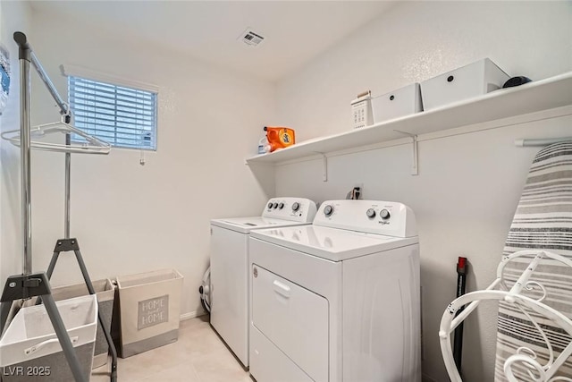 laundry room featuring visible vents, washing machine and dryer, and laundry area