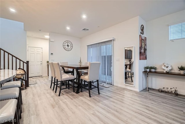 dining room featuring stairway, recessed lighting, visible vents, and wood finished floors