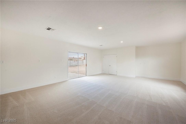 spare room with light carpet, visible vents, recessed lighting, and baseboards