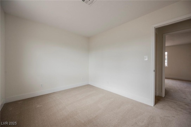 empty room featuring visible vents, baseboards, and carpet