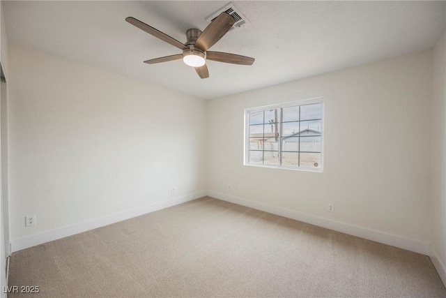 unfurnished room with baseboards, light carpet, and a ceiling fan