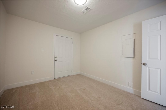 empty room with visible vents, baseboards, light colored carpet, and a textured ceiling