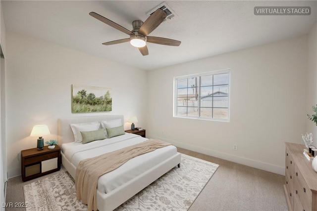 bedroom with light colored carpet, baseboards, and ceiling fan