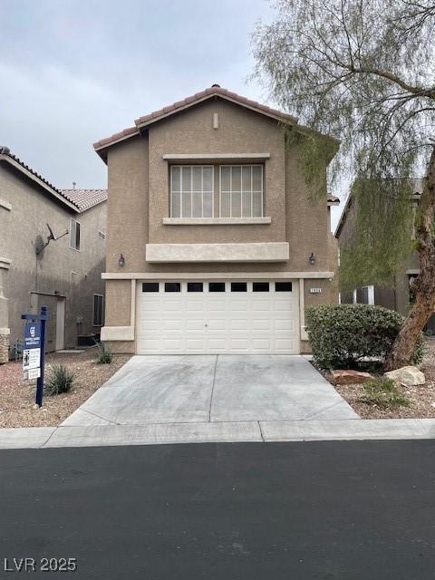 traditional-style home featuring stucco siding, concrete driveway, and an attached garage