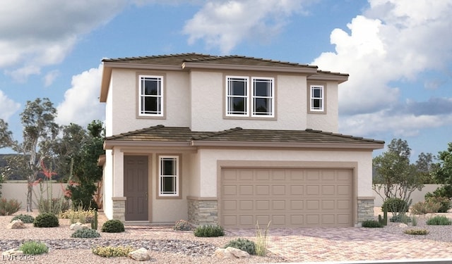 view of front of house featuring stone siding, stucco siding, an attached garage, and driveway