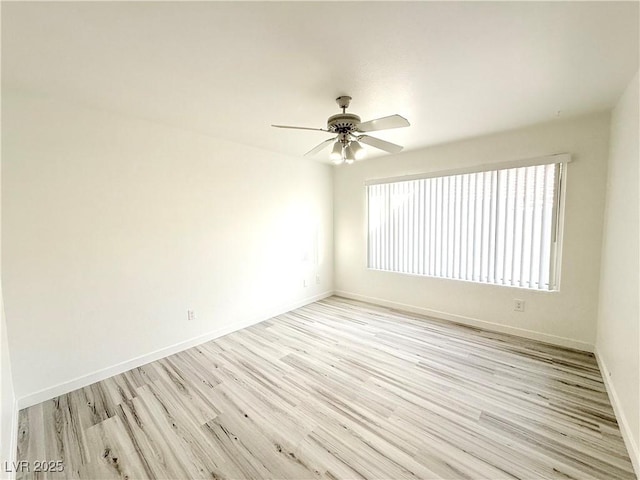 unfurnished room featuring baseboards, light wood-style floors, and ceiling fan