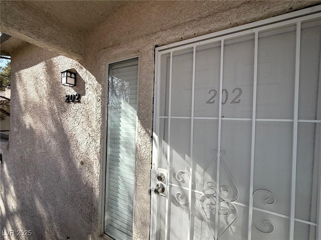 doorway to property with stucco siding