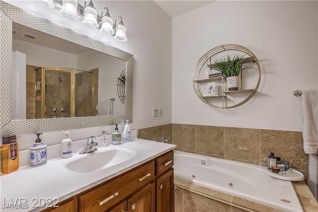 full bath featuring visible vents, a tub with jets, a stall shower, and vanity