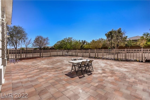 view of patio featuring outdoor dining area and fence