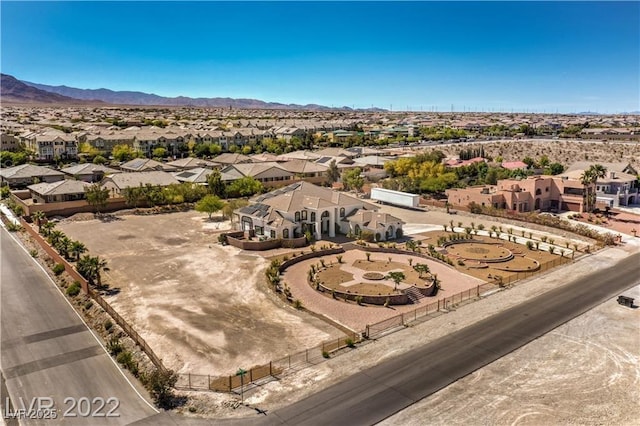 drone / aerial view featuring a residential view and a mountain view