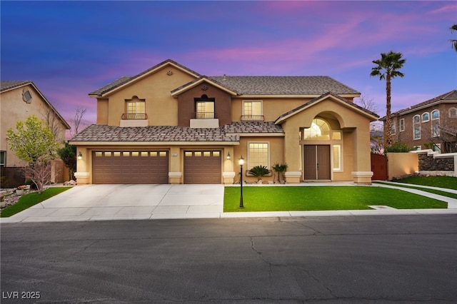 view of front of home featuring stucco siding, a yard, concrete driveway, and an attached garage