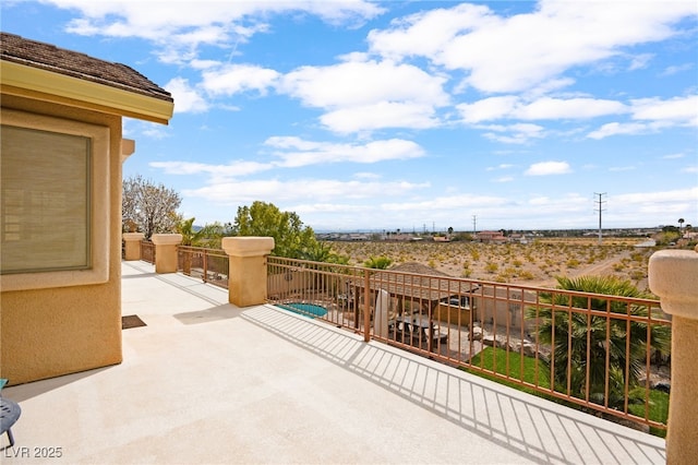 view of patio featuring a balcony