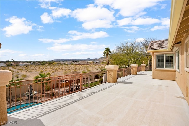 view of patio / terrace featuring a fenced in pool and a balcony