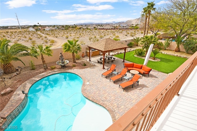 view of swimming pool with a fenced backyard, a gazebo, a mountain view, outdoor lounge area, and a patio area