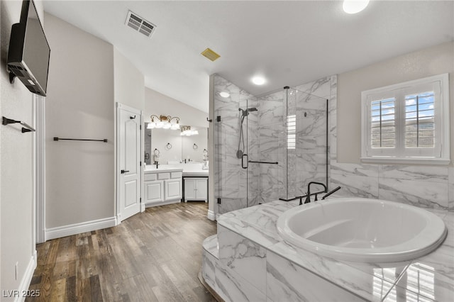 bathroom featuring vanity, visible vents, a marble finish shower, lofted ceiling, and a garden tub