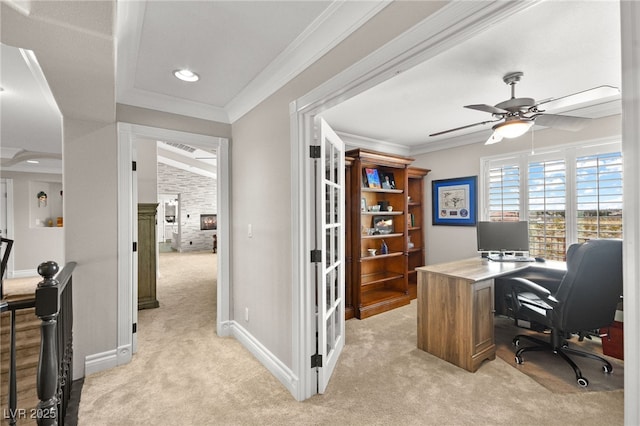 office featuring ceiling fan, crown molding, baseboards, and light carpet