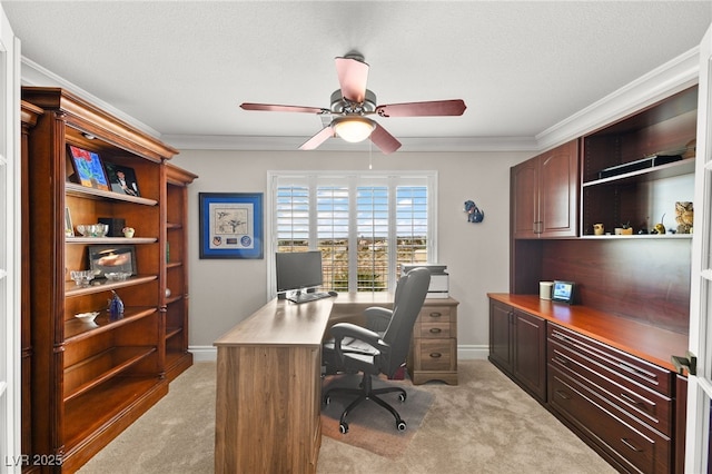 home office featuring light colored carpet, a ceiling fan, and ornamental molding