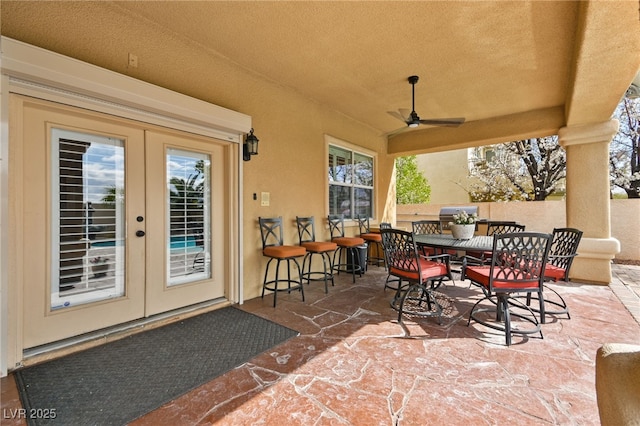 view of patio / terrace with outdoor dining space, french doors, a ceiling fan, and fence