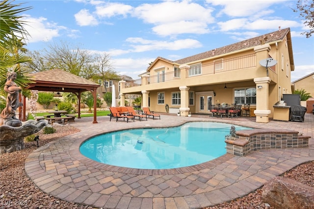 outdoor pool featuring a gazebo, french doors, outdoor dining space, and a patio area