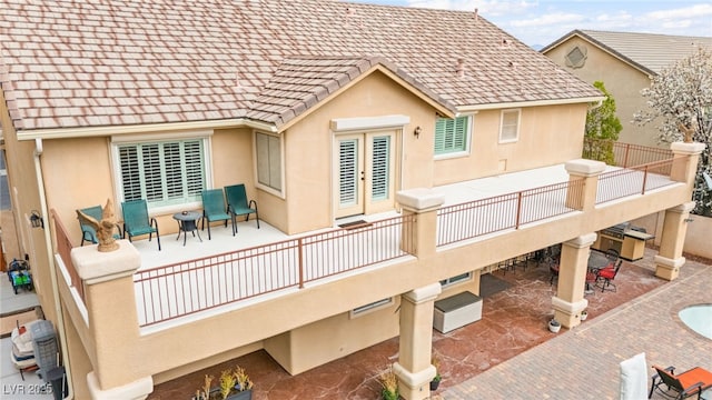 back of property featuring stucco siding, a patio, and french doors