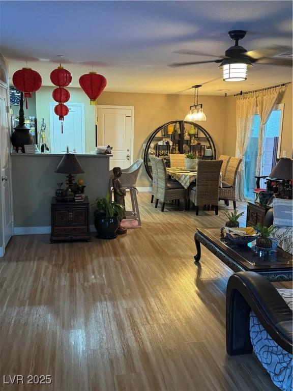 dining room with ceiling fan and wood finished floors