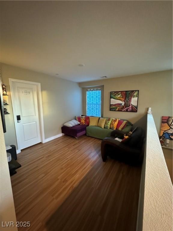 living area featuring wood finished floors and baseboards