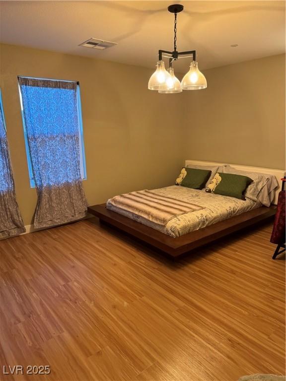 bedroom featuring visible vents and light wood-style floors