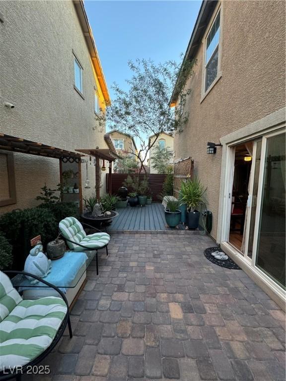 view of patio / terrace with a wooden deck and fence